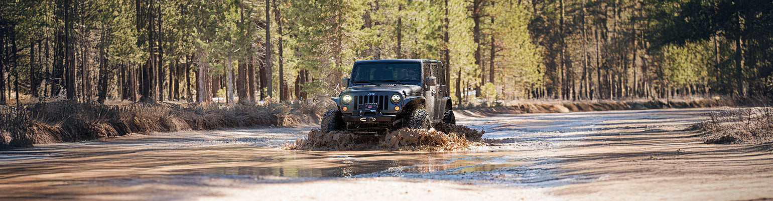 Rugged Radios Jeep two‑way GMRS radio kit with direct‑fit A‑pillar antenna mount and center‑console radio bracket for TJ, JK, JL, Gladiator, and Rubicon models
