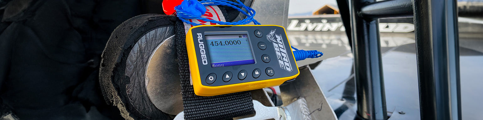 Single‑channel UHF race receivers (Nitro Bee) with earbud kit and car harness