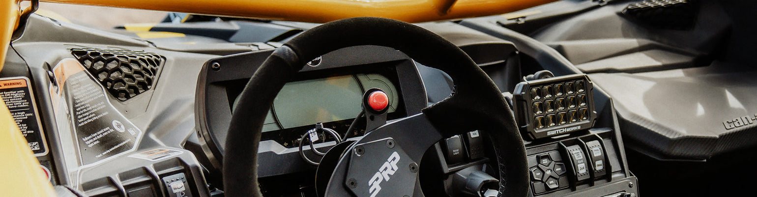 Rugged Radios Collection PTT parts and accessories—replacement red/clear button covers, full replacement buttons, 6‑bolt steering‑wheel PTT mount, intercom‑to‑car harness adapter, 3 ft extension cable, external PTT adapter cable, and belt‑station PTT unit.